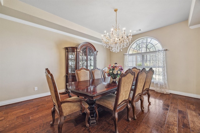 dining room with baseboards, a notable chandelier, and hardwood / wood-style floors