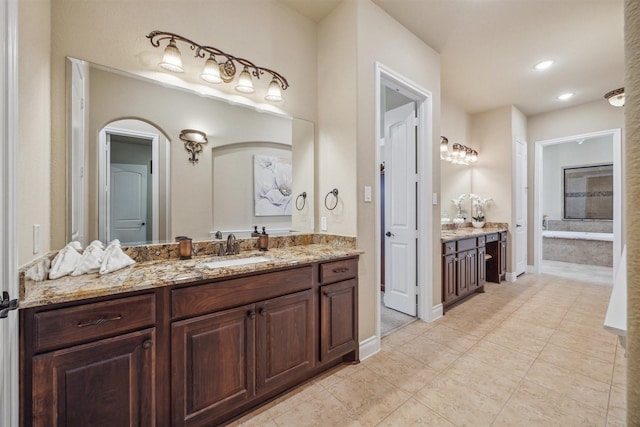 bathroom featuring baseboards, vanity, and tile patterned flooring