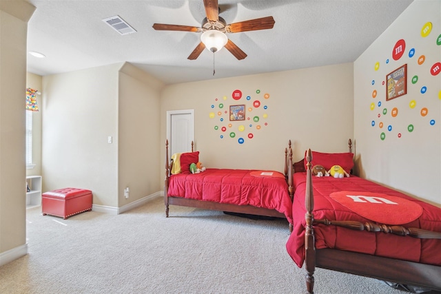 carpeted bedroom featuring visible vents, baseboards, a textured ceiling, and a ceiling fan