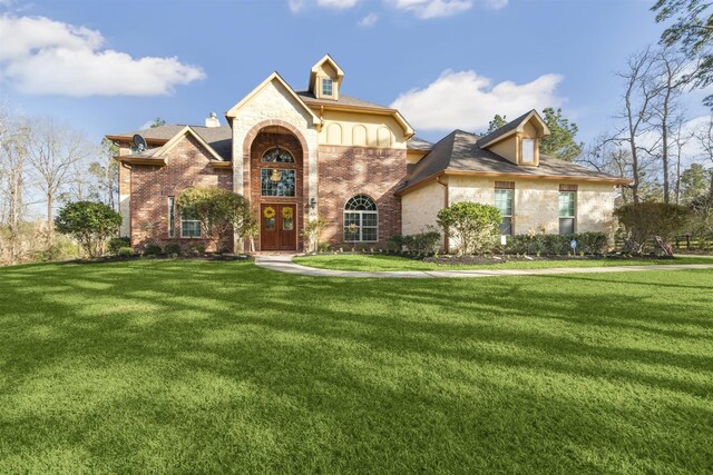 23421 Cannondale Loop, Montgomery, TX 77316 - traditional-style home with a front yard, brick siding, and french doors