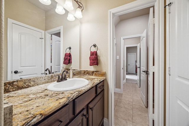 bathroom with tile patterned flooring, vanity, and baseboards