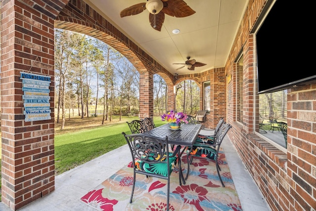 view of patio featuring outdoor dining area and a ceiling fan