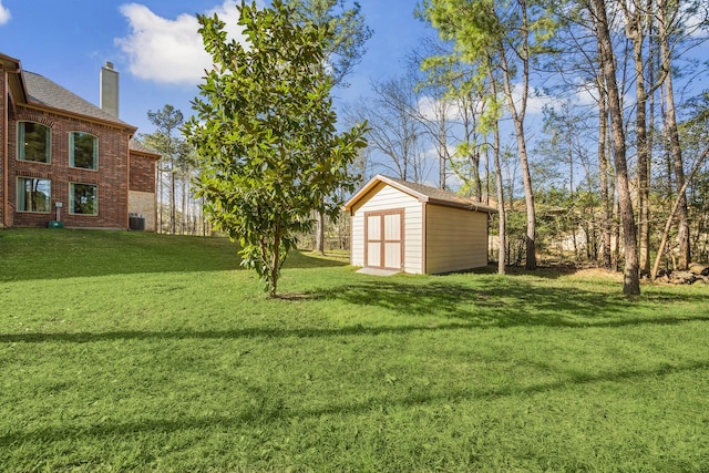 view of yard with an outbuilding, a storage unit, and cooling unit