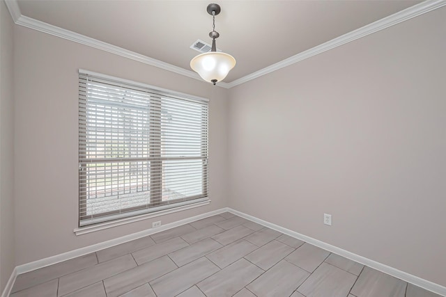 spare room featuring baseboards, visible vents, and ornamental molding