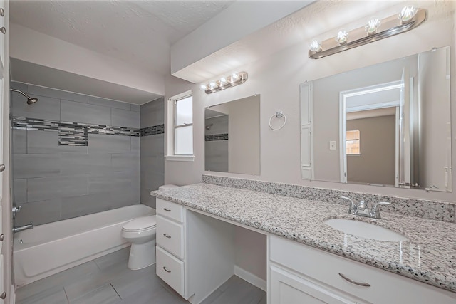 bathroom with tile patterned floors, shower / bathtub combination, toilet, and vanity