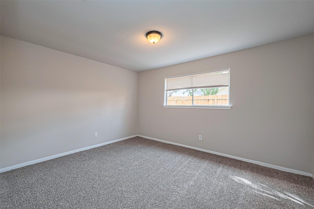 carpeted empty room with baseboards