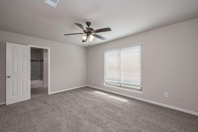 carpeted empty room featuring visible vents, baseboards, and a ceiling fan