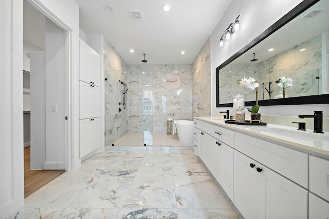 bathroom with visible vents, a marble finish shower, a freestanding bath, a sink, and marble finish floor