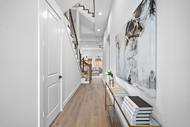 corridor featuring stairs, recessed lighting, wood finished floors, and baseboards