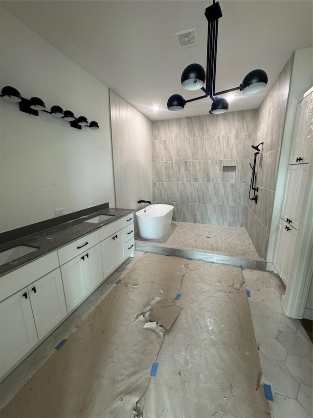 full bathroom featuring a soaking tub, visible vents, a walk in shower, and vanity