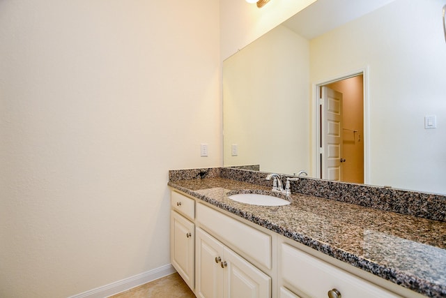 bathroom with baseboards and vanity