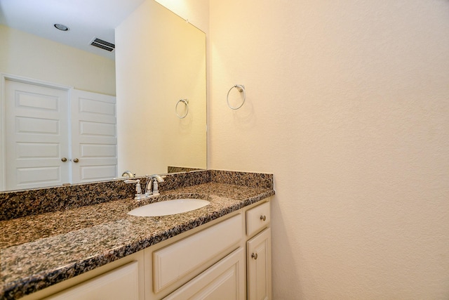 bathroom with visible vents and vanity