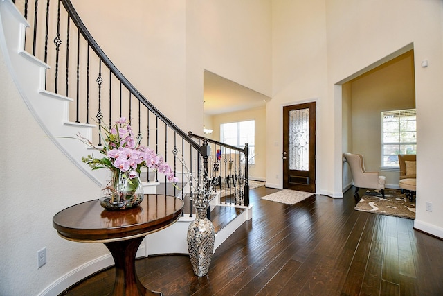 entryway with baseboards, a healthy amount of sunlight, stairs, and hardwood / wood-style flooring