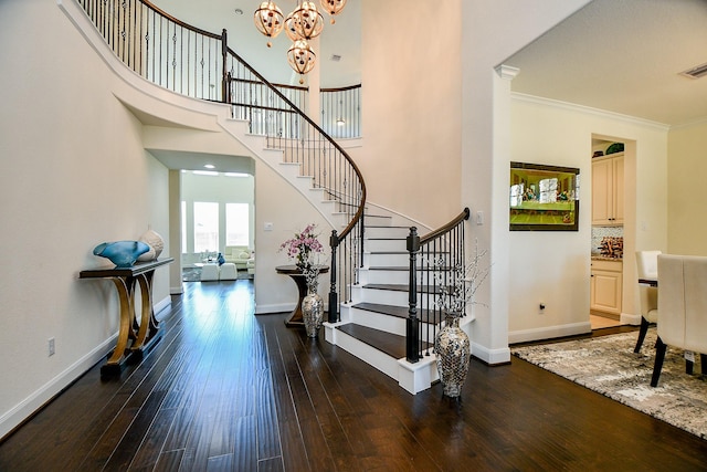 entrance foyer with ornamental molding, baseboards, and hardwood / wood-style floors