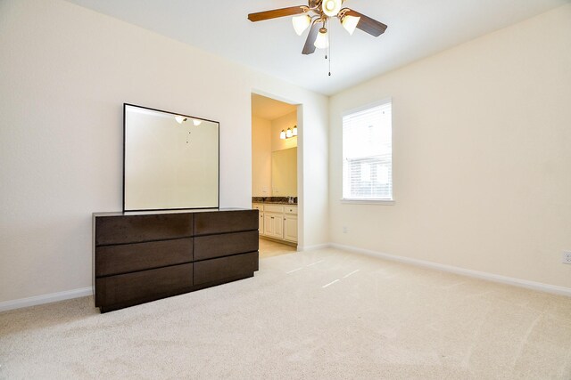 bedroom with baseboards and light carpet