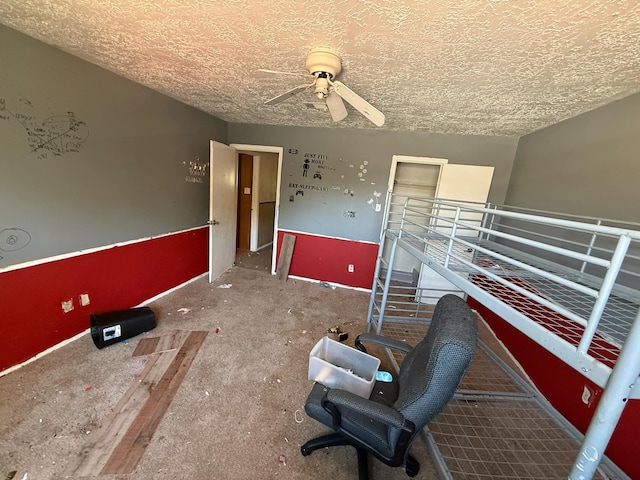 spare room featuring a ceiling fan and a textured ceiling