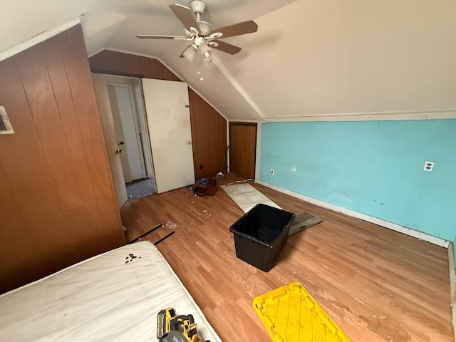 additional living space with a ceiling fan, lofted ceiling, and wood finished floors