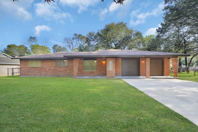 view of front of home featuring a front lawn, fence, concrete driveway, an attached garage, and brick siding