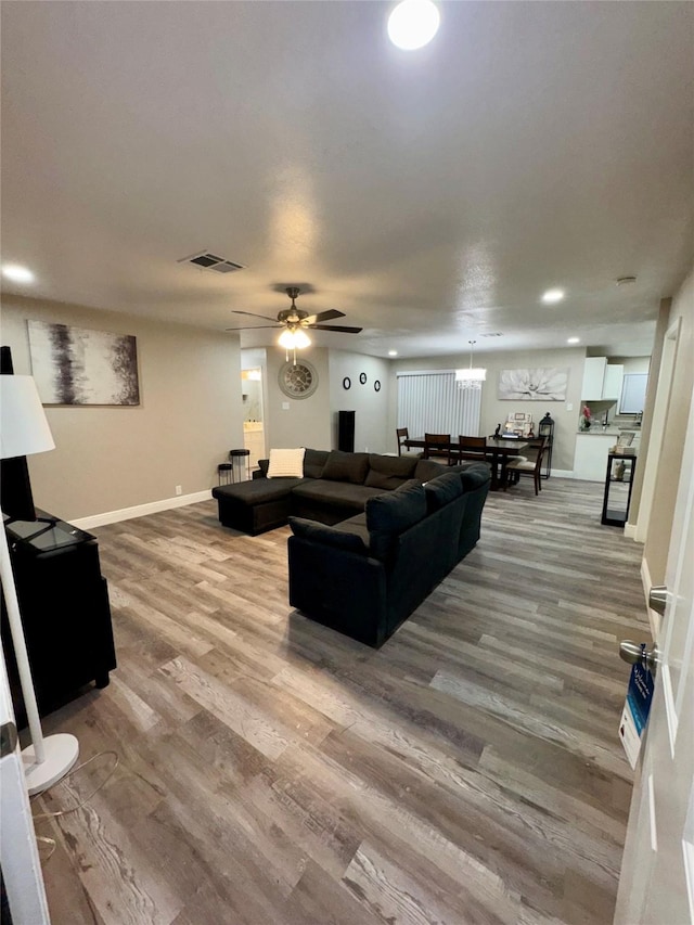 806 Moody Ave, League City, TX 77573 - living room with a ceiling fan, wood finished floors, visible vents, and baseboards