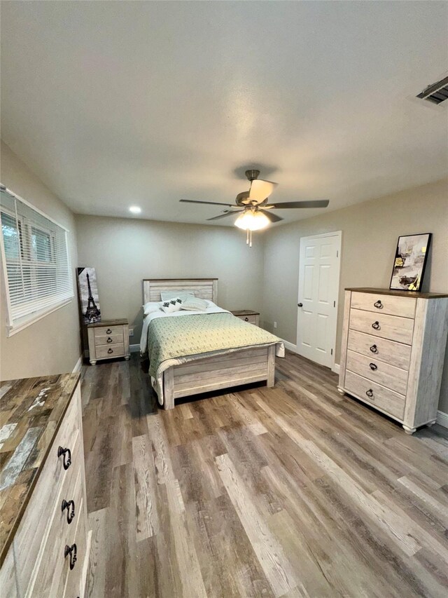 806 Moody Ave, League City, TX 77573 - bedroom with dark wood-type flooring, baseboards, visible vents, and ceiling fan