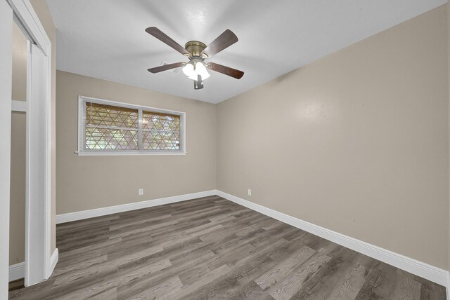 806 Moody Ave, League City, TX 77573 - unfurnished room with dark wood-type flooring, a ceiling fan, and baseboards