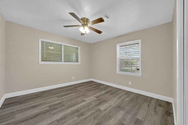 806 Moody Ave, League City, TX 77573 - empty room featuring a ceiling fan, visible vents, wood finished floors, and baseboards
