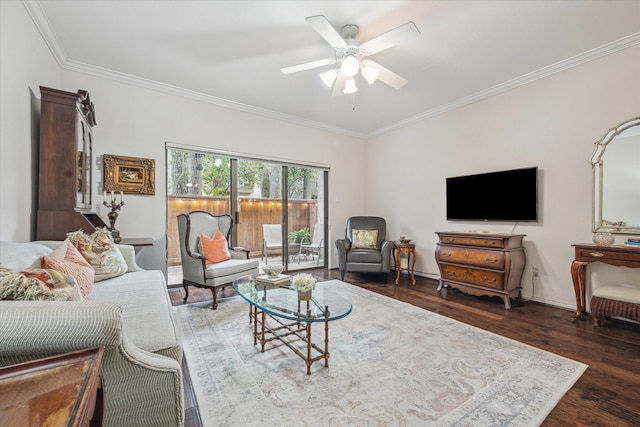 living room with ornamental molding, a ceiling fan, and wood finished floors