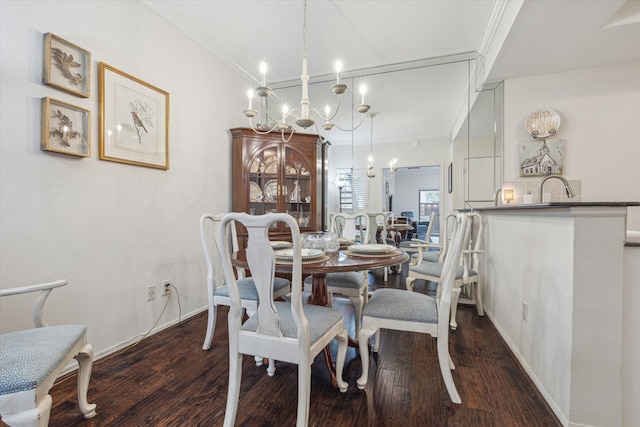 dining area with dark wood finished floors, an inviting chandelier, baseboards, and ornamental molding