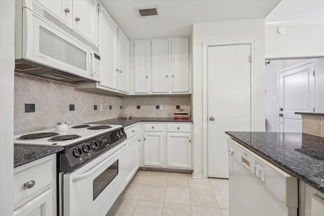 kitchen with white appliances, white cabinets, tasteful backsplash, and visible vents