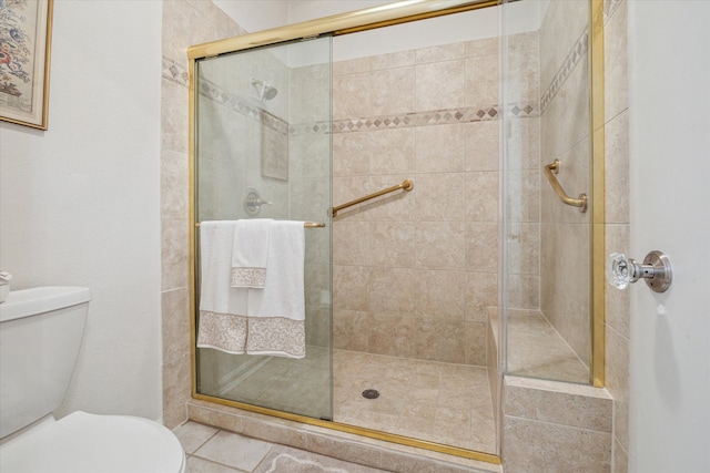 full bath featuring tile patterned flooring, toilet, and a stall shower