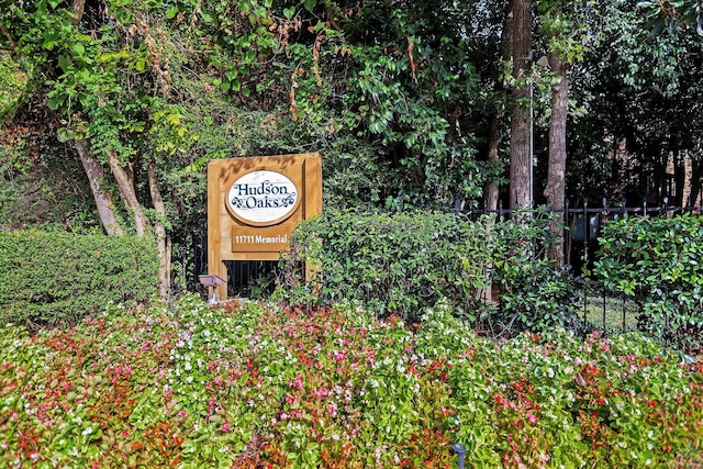 community sign featuring fence