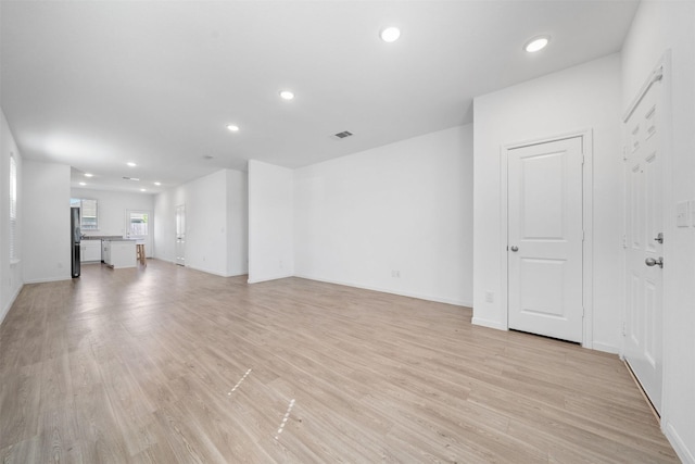 unfurnished living room featuring recessed lighting, visible vents, and light wood-style flooring