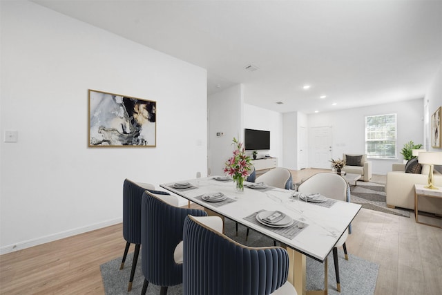 dining space with recessed lighting, baseboards, and light wood finished floors