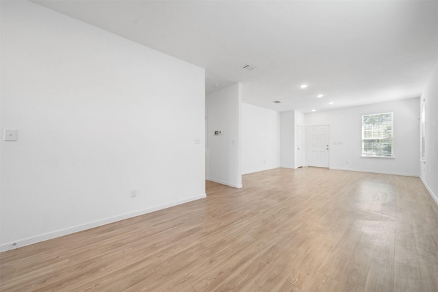 unfurnished room featuring recessed lighting, baseboards, and light wood-style floors