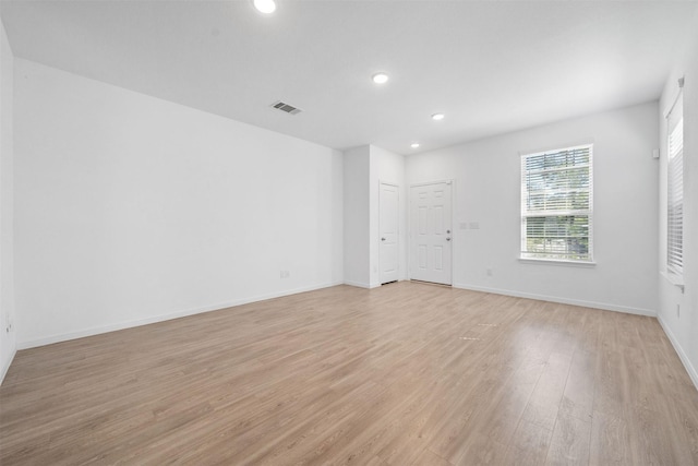 unfurnished room featuring recessed lighting, visible vents, baseboards, and light wood-style floors