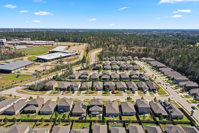 aerial view featuring a residential view and a wooded view