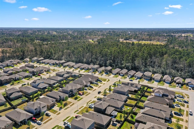 bird's eye view with a wooded view and a residential view