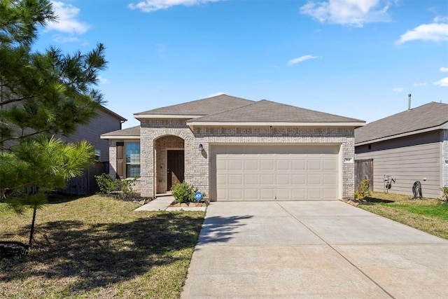 french country home with brick siding, a front lawn, fence, a garage, and driveway