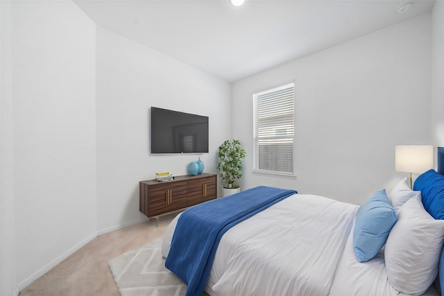 bedroom featuring carpet and baseboards