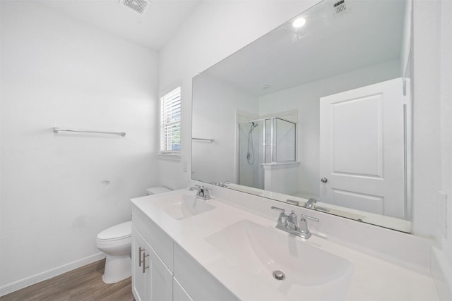 full bath with visible vents, toilet, and a sink