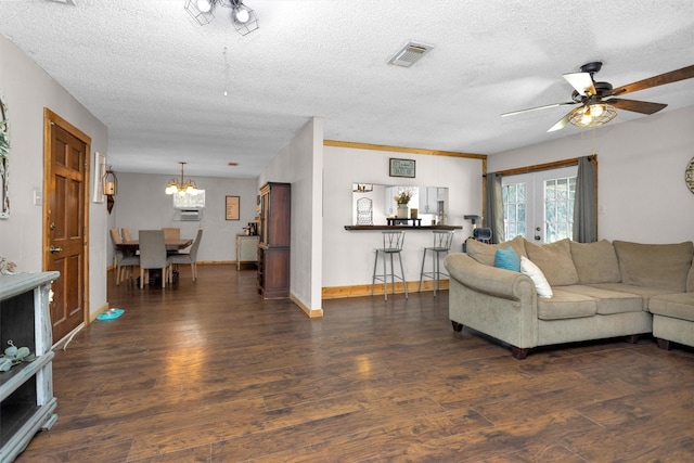 living room featuring visible vents, a textured ceiling, wood finished floors, and french doors