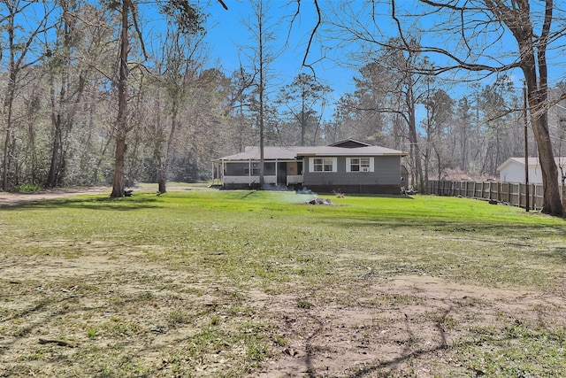 view of yard featuring a sunroom and fence