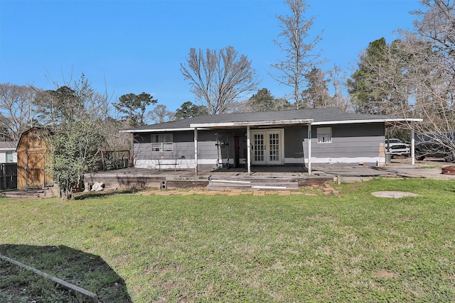 rear view of property featuring a patio, a yard, and french doors