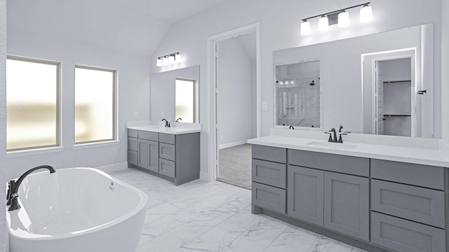 12247 Sweet Gum Dr, Mont Belvieu, TX 77523 - bathroom with marble finish flooring, a freestanding bath, tiled shower, two vanities, and vaulted ceiling