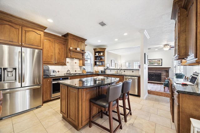 1107 Chesterwood Dr, Pearland, TX 77581 - kitchen with stainless steel appliances, ceiling fan, healthy amount of natural light, open shelves, and recessed lighting