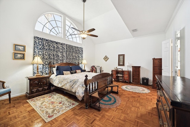 bedroom featuring a ceiling fan, a high ceiling, and baseboards