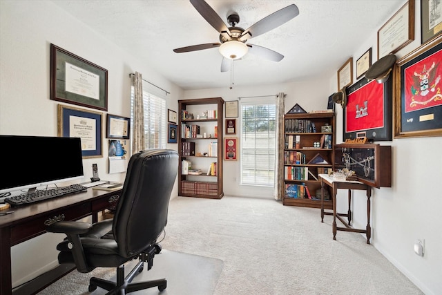 office with carpet flooring, a textured ceiling, baseboards, and ceiling fan