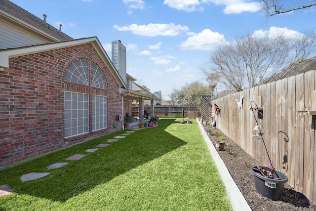 view of yard with a fenced backyard