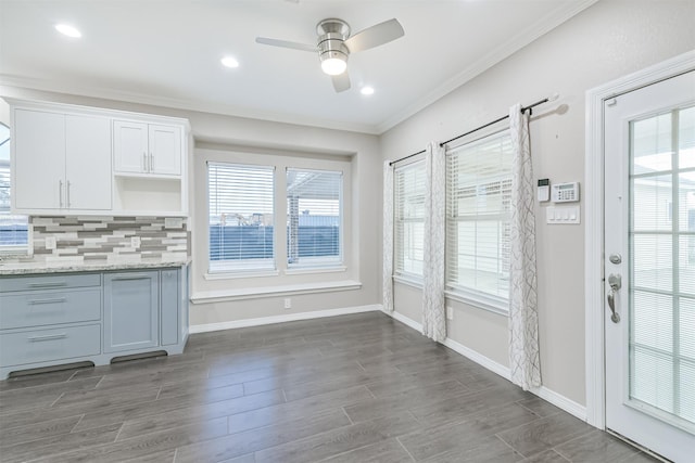 unfurnished dining area featuring baseboards, recessed lighting, dark wood-style flooring, ceiling fan, and ornamental molding