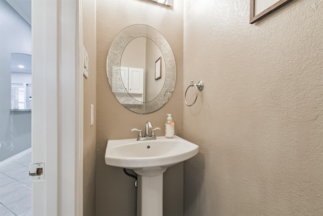 bathroom with a sink and a textured wall